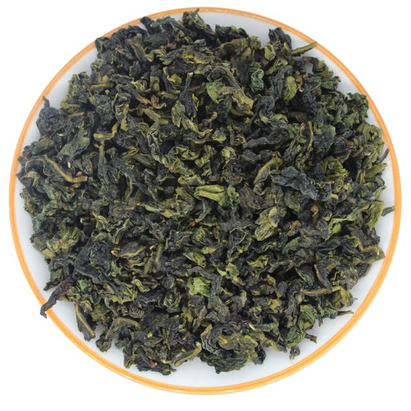 dry tea leaves of Light Fragrance AAA Grade Tie Guan Yin Oolong Tea in a white plate