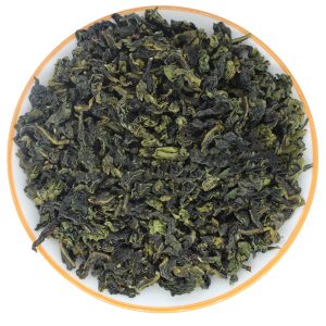 dry tea leaves of Light Fragrance Tie Guan Yin in a white plate
