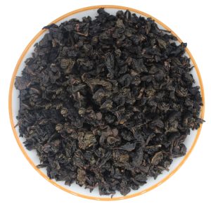 dry tea leaves of Strong Fragrance Tie Guan Yin in a white plate