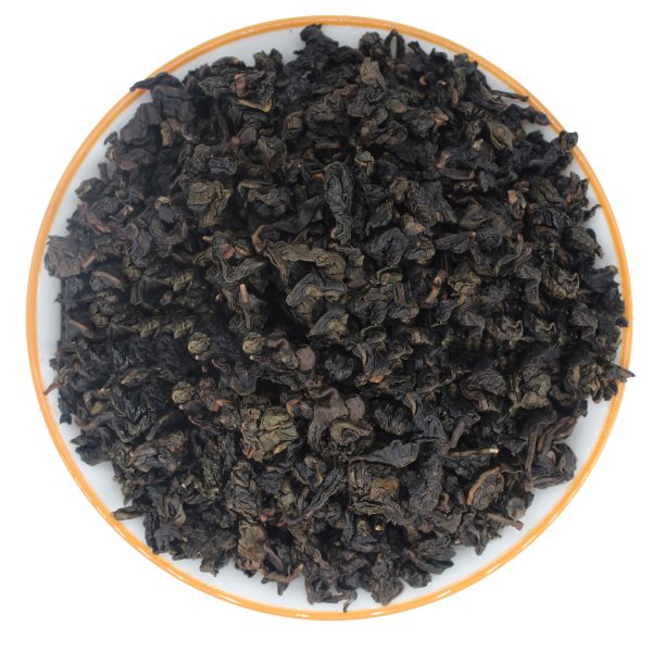 dry tea leaves of Strong Fragrance Tie Guan Yin in a white plate