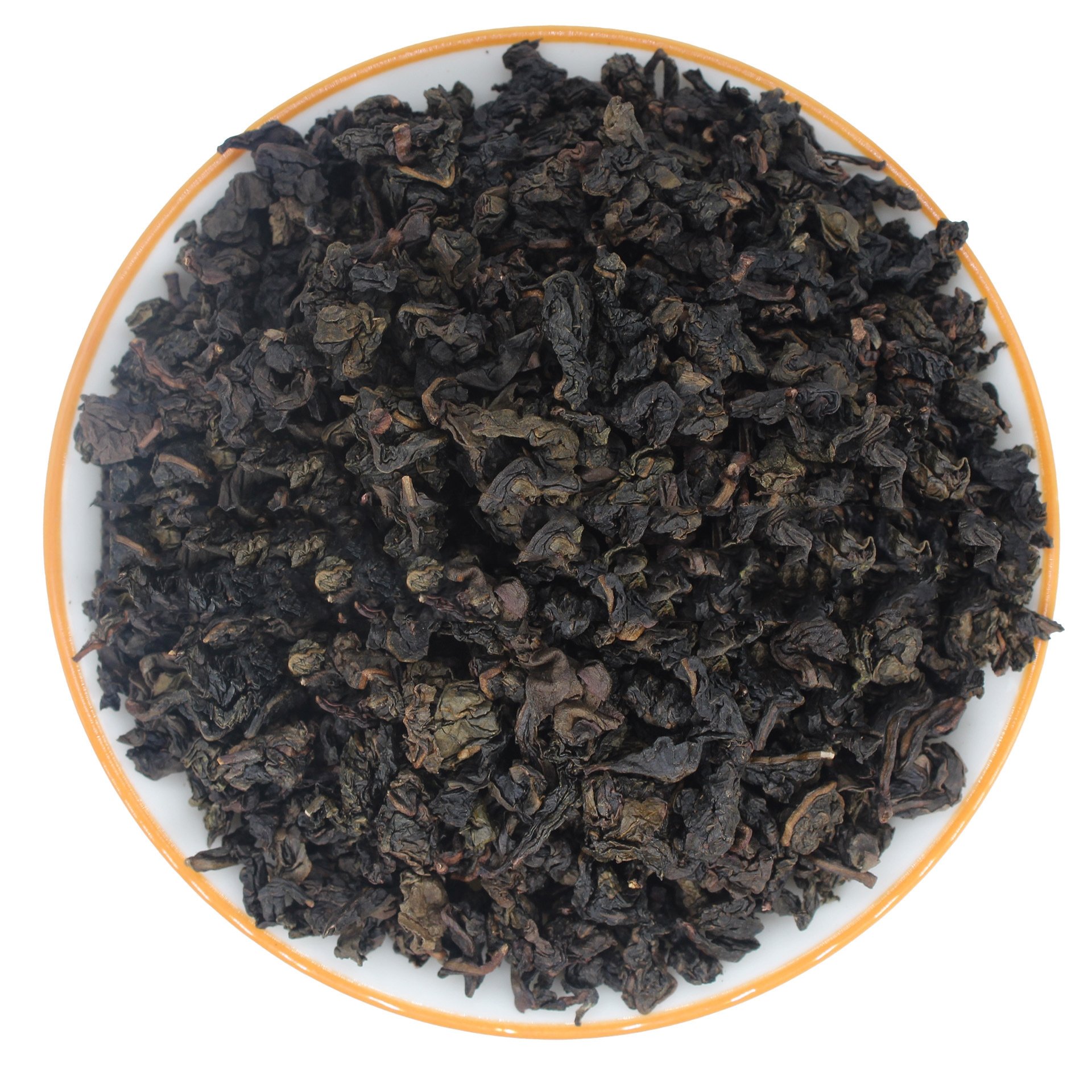 dry tea leaves of Strong Fragrance Tie Guan Yin in a white plate dry tea leaves of Strong Fragrance Tie Guan Yin in a white plate