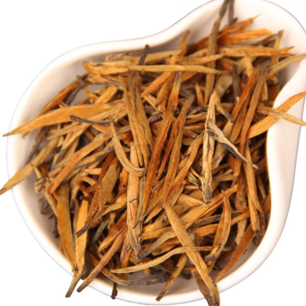 dry loose leaf of golden needle black tea in a plate